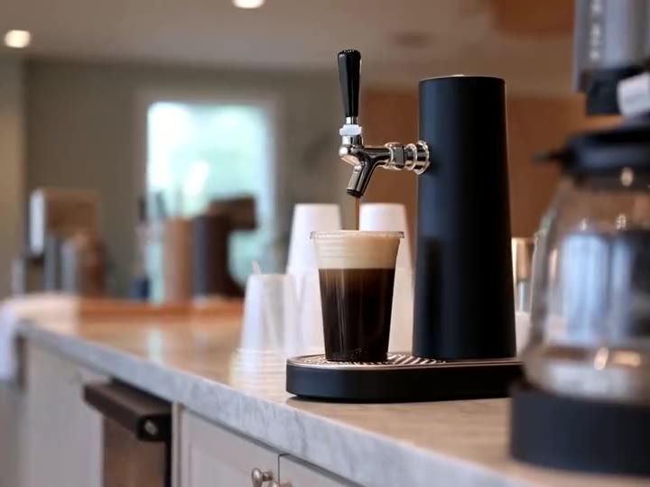 A nitro tap on a breakroom counter beside the existing coffee maker